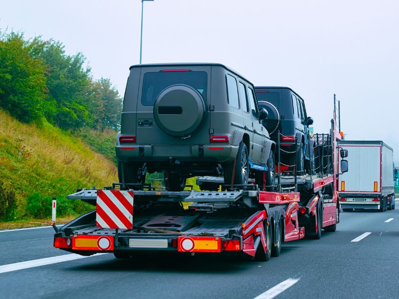 Luxury cars transport truck on road Luxury cars transport truck on road